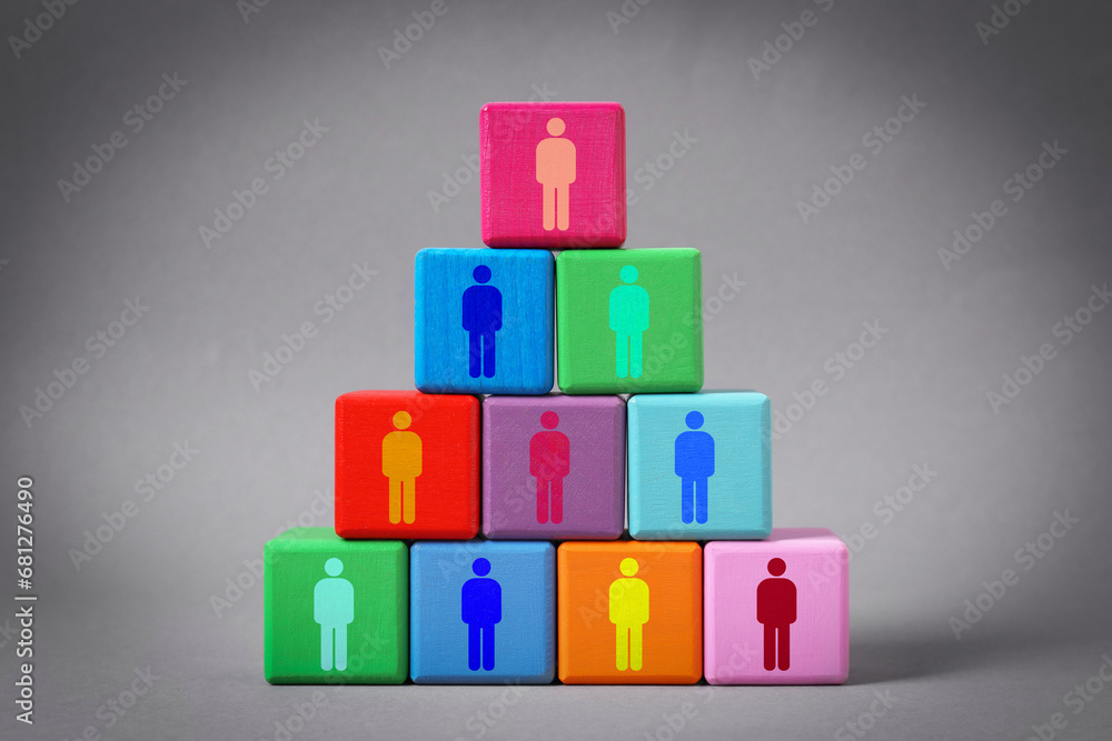Team and management concept. Pyramid of colorful cubes with human icons on grey background Team and management concept. Pyramid of colorful cubes with human icons on grey background