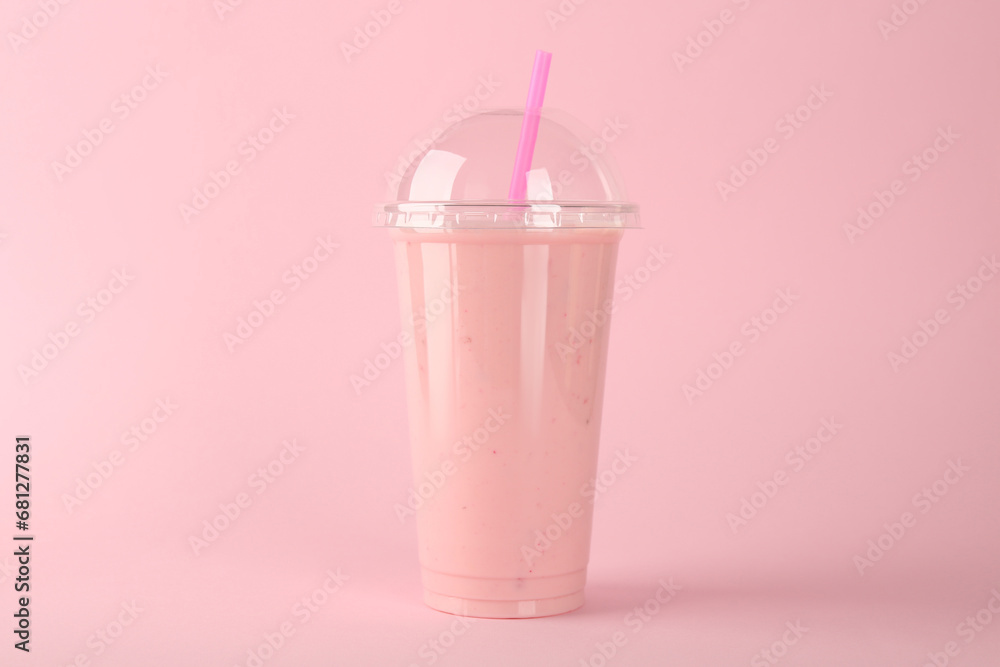 Plastic cup of tasty smoothie on pink background Plastic cup of tasty smoothie on pink background