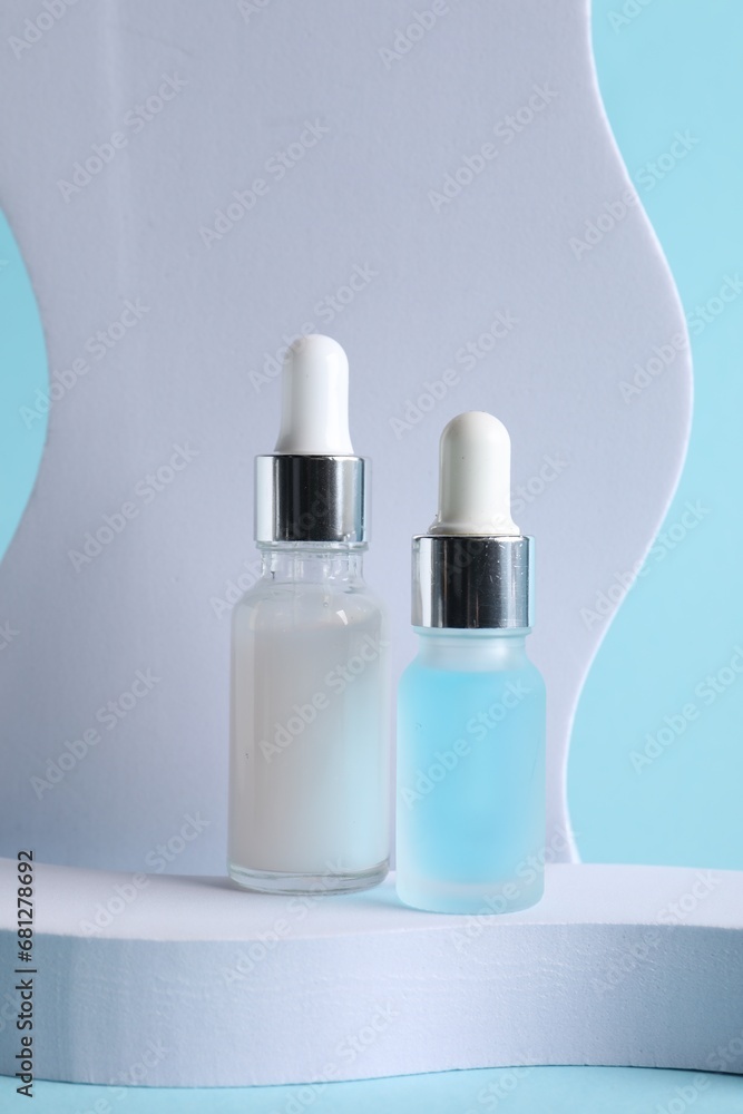 Stylish presentation of cosmetic serum on light blue background Stylish presentation of cosmetic serum on light blue background