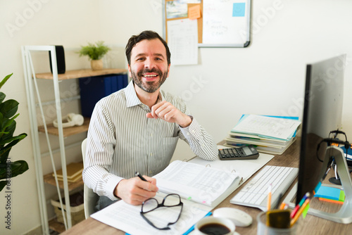 Excited handsome man enjoying his work as a manager