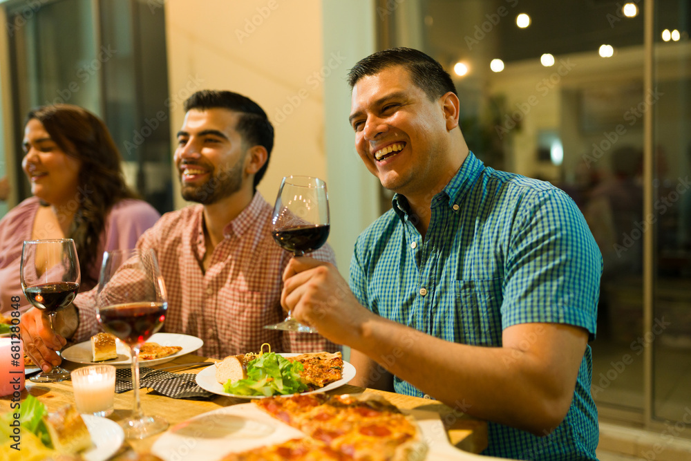 Attractive latin man having dinner with his friends