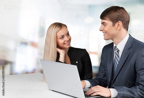 manager teaching young worker discussing strategy