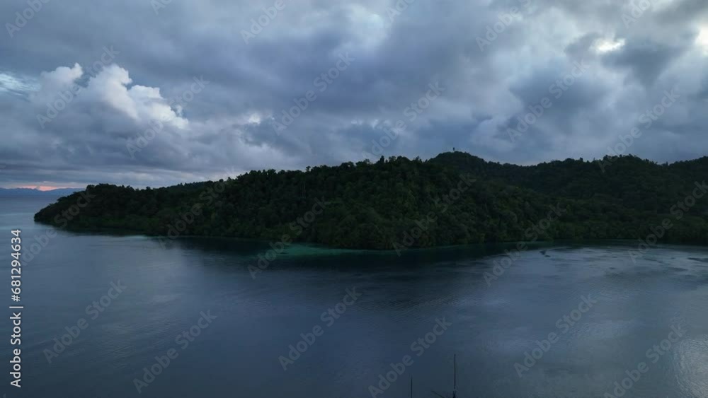 Low clouds drift across the island of Batanta in Raja Ampat, Indonesia, at dawn. This area is known as the heart of the Coral Triangle due to its incredibly high marine biodiversity. Low clouds drift across the island of Batanta in Raja Ampat, Indonesia, at dawn. This area is known as the heart of the Coral Triangle due to its incredibly high marine biodiversity.