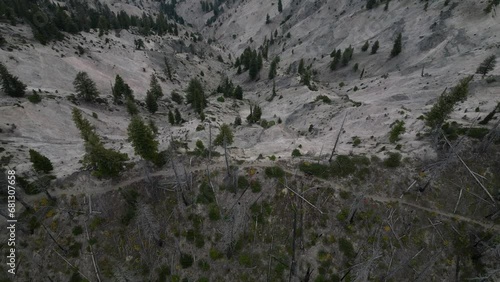 Top down aerial of dirt biker on trail on mountain ridge line in Idaho photo