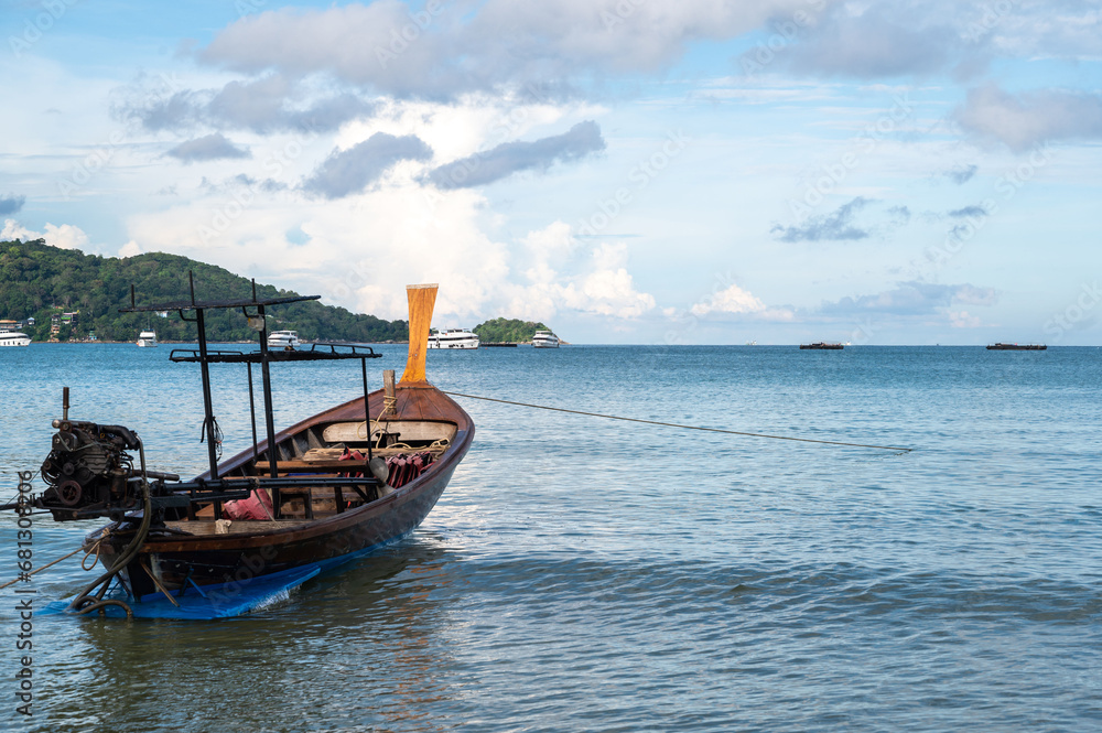 Long tail boat moored at Patong beach in summer, Thailand, used for travel.