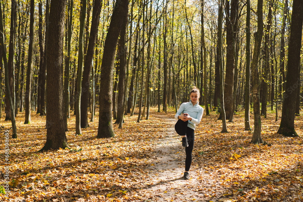 Beautiful girl doing fitness in nature on a sunny autumn forest. Body positive, sports for women, harmony, healthy lifestyle, self-love and wellness. Beautiful girl doing fitness in nature on a sunny autumn forest. Body positive, sports for women, harmony, healthy lifestyle, self-love and wellness.