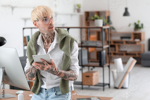Young tattooed man working ...