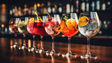 set of glass of champagne, colorful gin tonic cocktails in glasses on bar counter in pup or restaurant.