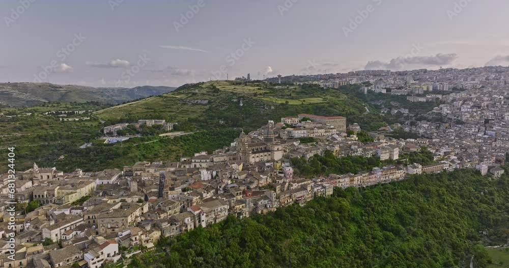 Ragusa Italy Aerial v3 panoramic view drone flyover the valley around historic hillside town of Ibla capturing Duomo di San Giorgio cathedral church nestled within - Shot with Mavic 3 Cine - June 2023 Ragusa Italy Aerial v3 panoramic view drone flyover the valley around historic hillside town of Ibla capturing Duomo di San Giorgio cathedral church nestled within - Shot with Mavic 3 Cine - June 2023