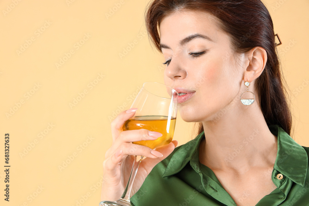 Beautiful young woman with glass of wine on beige background, closeup Beautiful young woman with glass of wine on beige background, closeup
