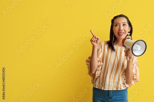 Young Asian woman with mega...