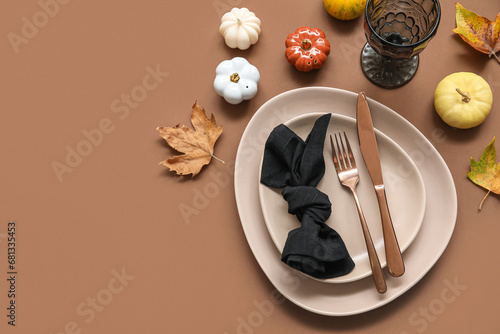 Stylish table setting with autumn decor on brown background