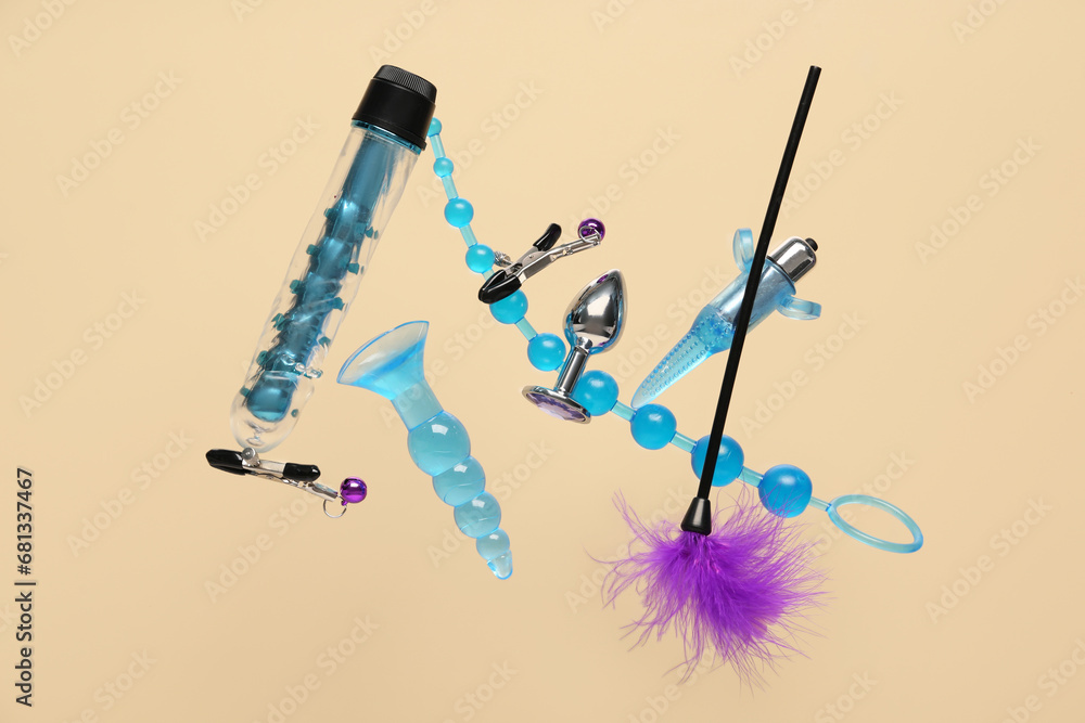 Flying sex toys on beige background Flying sex toys on beige background