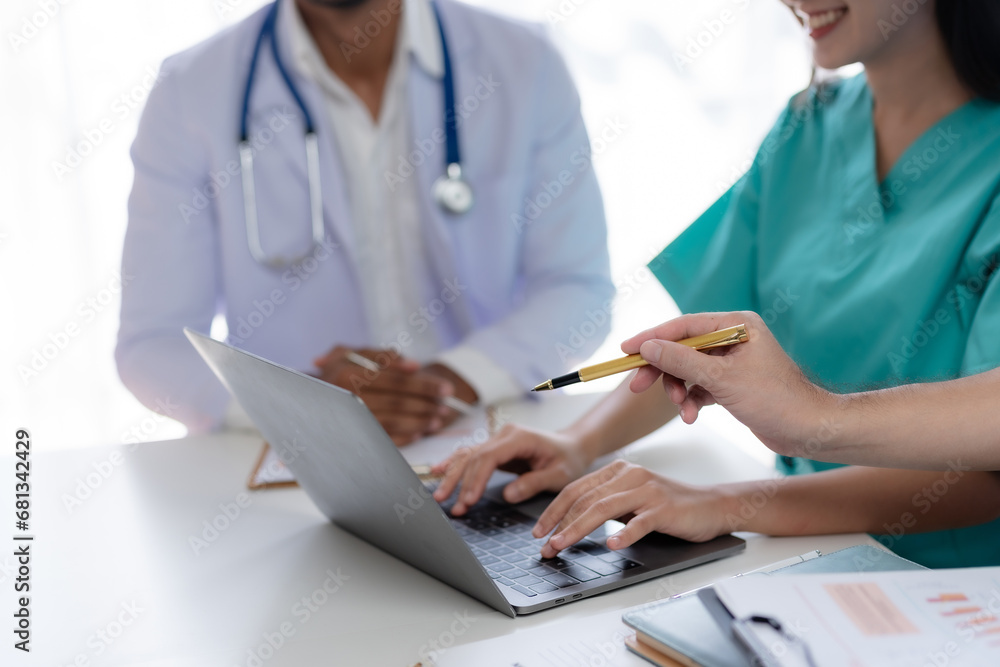 Doctor discussing diagnosis during the meeting. Group of doctor discussing work matter in the office at work. The medical team discusses treatment options with the patient.