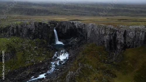 Snaedalsfoss Waterfall off Cliff in Cloudy, Gloomy Iceland Landscape, Aerial photo