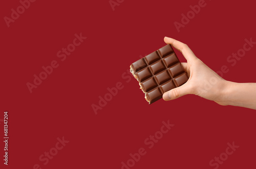 Hand holding a bitten choco...