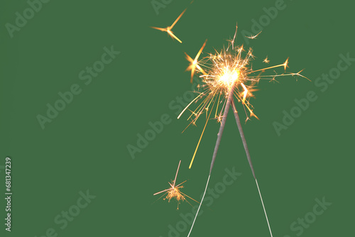 Beautiful Christmas sparklers on green background