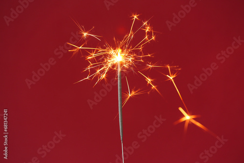 Fototapeta Naklejka Na Ścianę i Meble -  Beautiful Christmas sparkler on red background