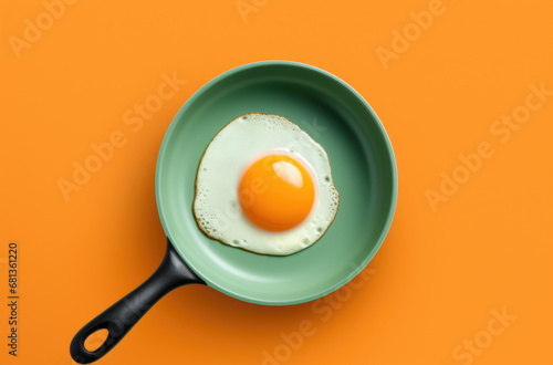 Creative food concept with fried egg on pan over yellow background. Top view. Creative pattern in minimal style. Flat lay. Square crop