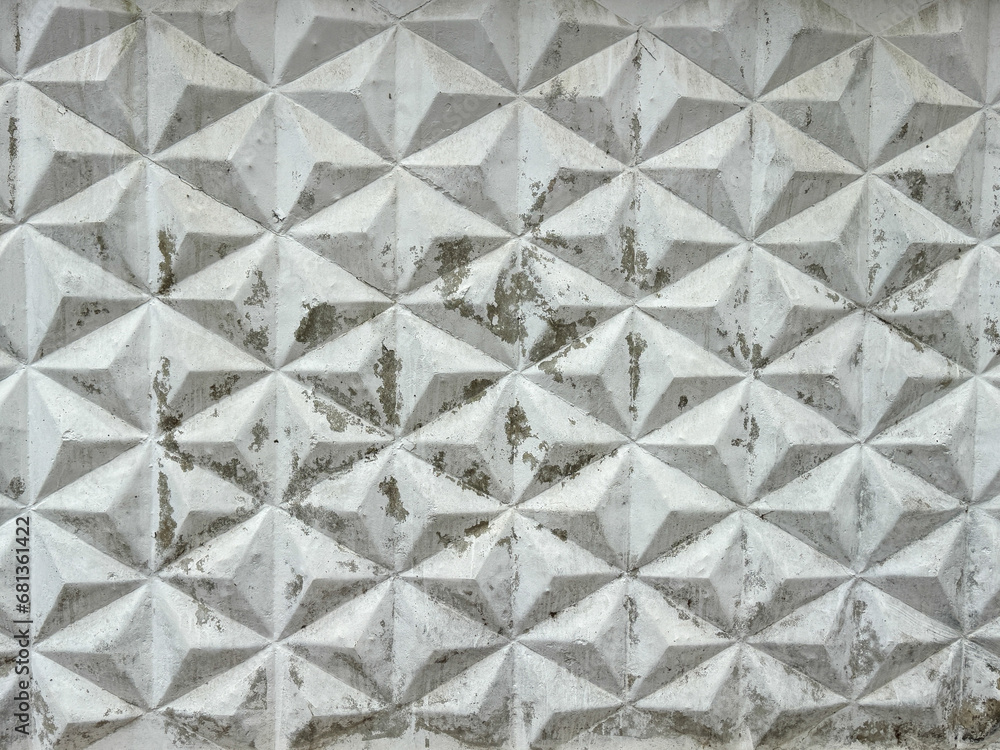 Fototapeta premium Patterned white concrete fence as background. Texture