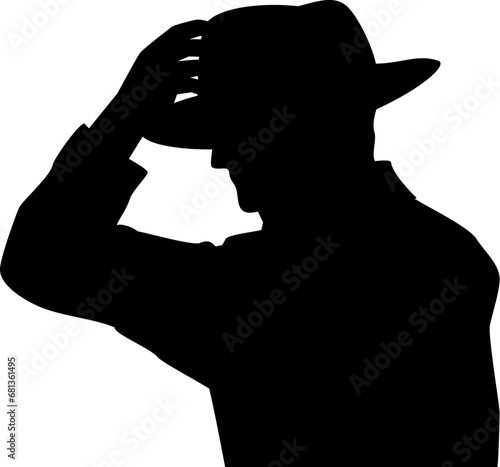 中折れ帽とトレンチコートの人物のシルエット