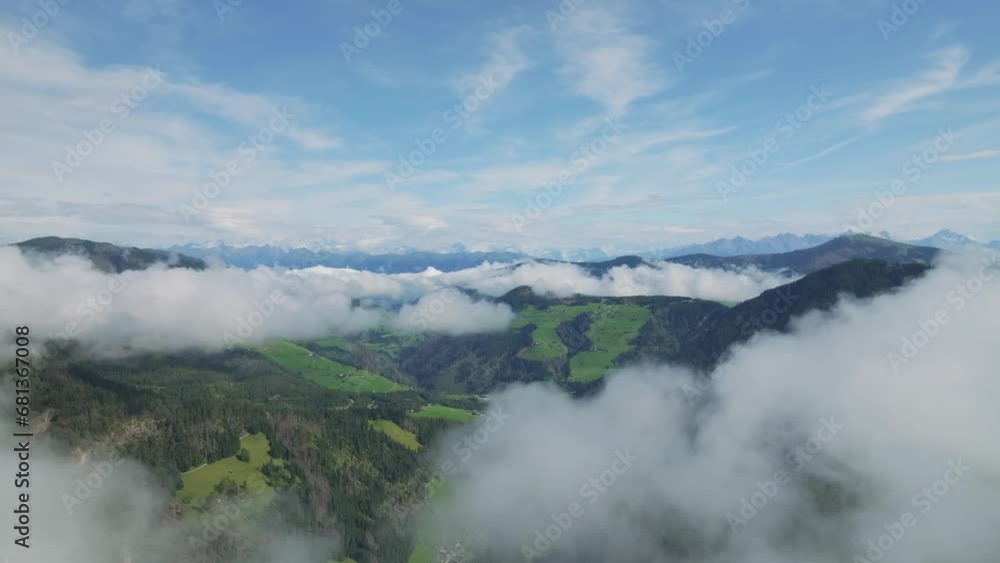 Drone soars amidst Dolomite peaks, veiled in clouds over La Val and it reveals the village in the valley. Summer morning's breathtaking aerial dance. LuPa Creative Drone soars amidst Dolomite peaks, veiled in clouds over La Val and it reveals the village in the valley. Summer morning's breathtaking aerial dance. LuPa Creative