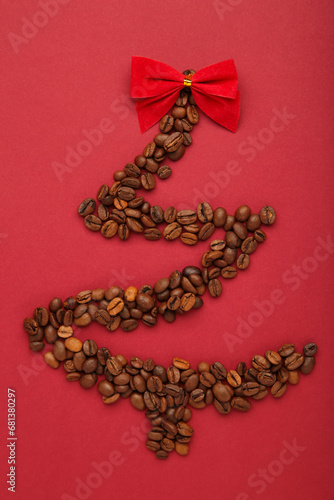 Christmas tree made from coffee beans on red background.