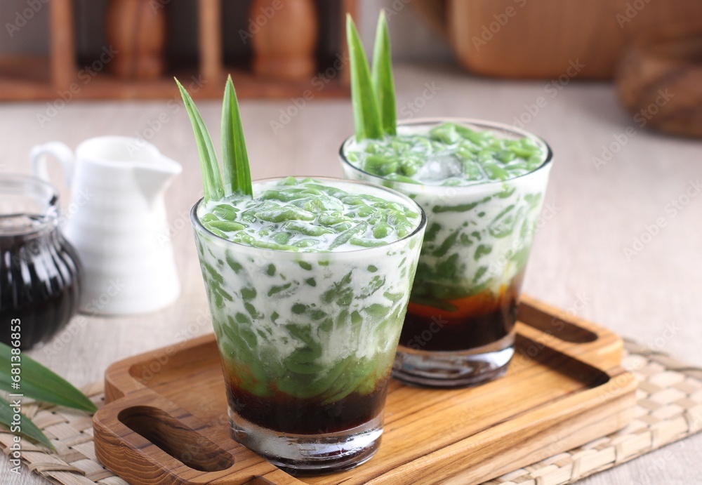 Cendol is a sweet dessert that contains droplets of green rice flour jelly, coconut milk and palm sugar syrup. It is served with shaved ice and is a refreshing snack in hot weather. Cendol is a sweet dessert that contains droplets of green rice flour jelly, coconut milk and palm sugar syrup. It is served with shaved ice and is a refreshing snack in hot weather.