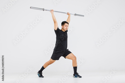 Portrait isolated cutout full body studio shot strong Asian male fitness athlete sportman model in black casual sport workout outfit posing smiling lifting barbell exercising on white background photo