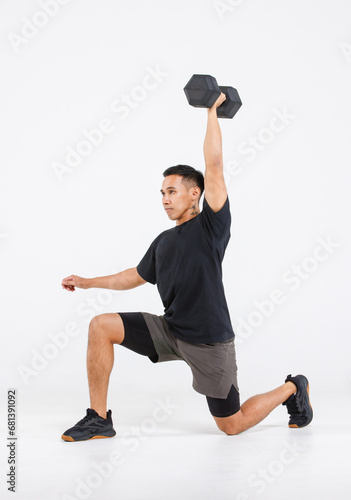 Isolated cutout full body studio shot of strong Asian male fitness athlete sportman trainer model in black casual sport workout outfit posing lifting dumbbell and lunge exercising on white background