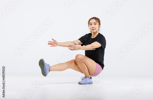 Portrait isolated cutout full body studio shot strong Asian female fitness athlete sportswoman trainer model in casual sport workout outfit posing one leg squat training exercising on white background