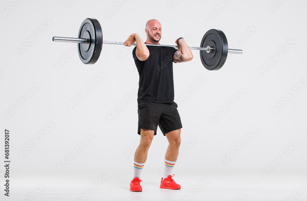 Portrait isolated cutout full body studio shot strong Caucasian male fitness athlete sporstman trainer model in casual sport workout outfit posing lifting barbell training on white background. Portrait isolated cutout full body studio shot strong Caucasian male fitness athlete sporstman trainer model in casual sport workout outfit posing lifting barbell training on white background.