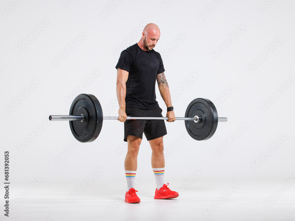 Portrait isolated cutout full body studio shot strong Caucasian male fitness athlete sporstman trainer model in casual sport workout outfit posing lifting barbell training on white background.