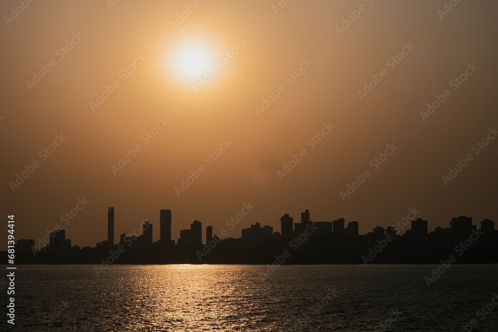 Mumbai downtown sunset cityscape India. City in the setting sun. A bright colourful sunset sky over the black silhouettes cityscape.