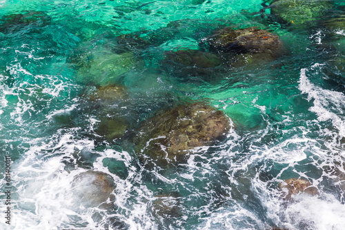 Coastal stones are under blue ocean water, Seychelles