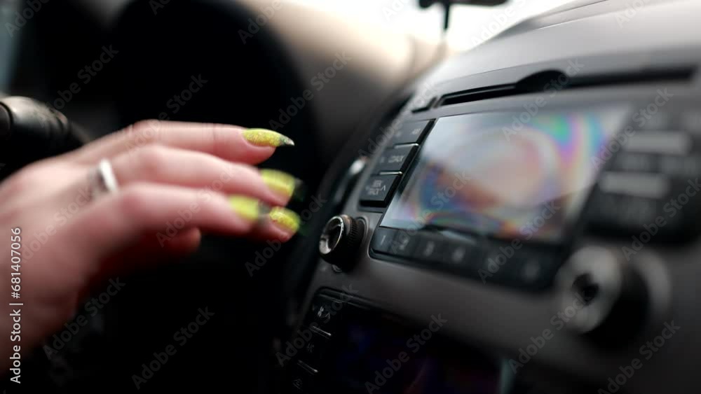 female hand turns on the radio in the car, beautiful fingers female hand turns on the radio in the car, beautiful fingers