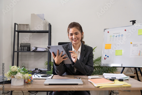 Young business woman executive worker holding digital tablet using pad technology device working in office