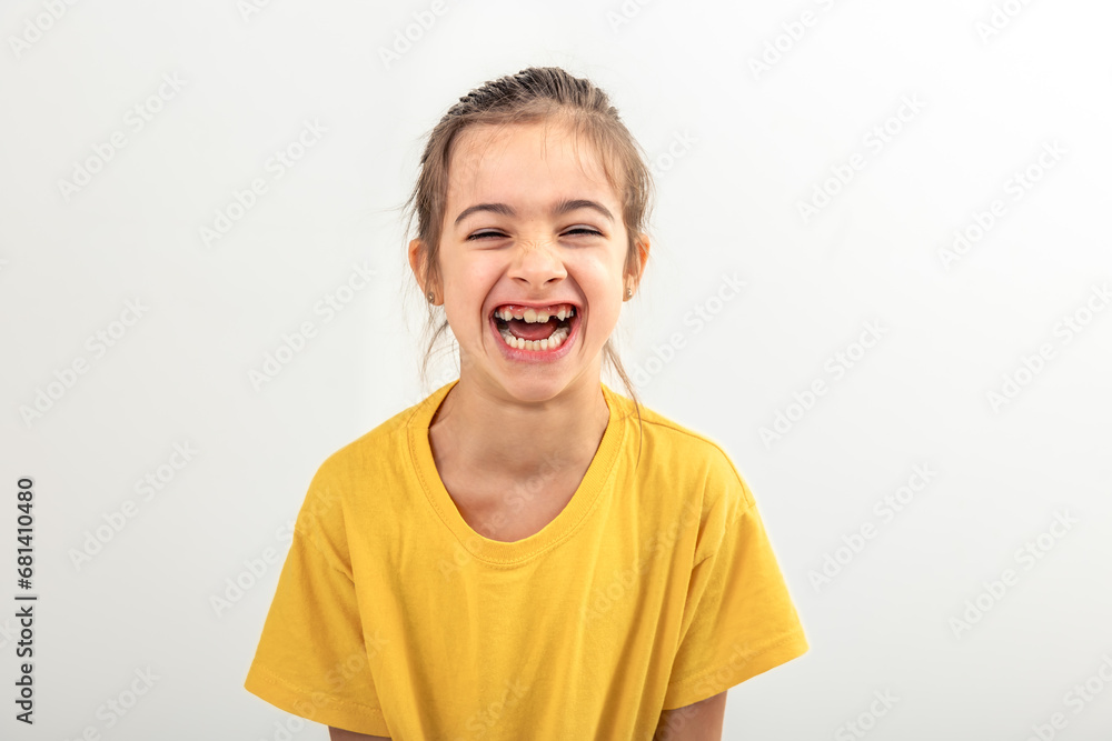Little girl laughs cheerfully on a white background isolated. Little girl laughs cheerfully on a white background isolated.
