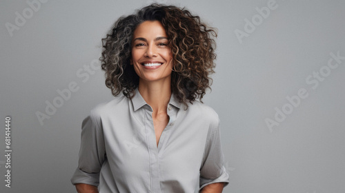 Happy mature african american businesswoman smiling at camera isolated on grey.
