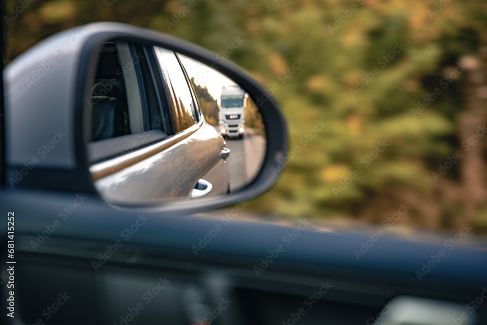 The view of the road in the car's rearview mirror. The view of the road in the car's rearview mirror.