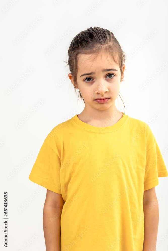 Sad Caucasian little girl on a white background isolated. Sad Caucasian little girl on a white background isolated.