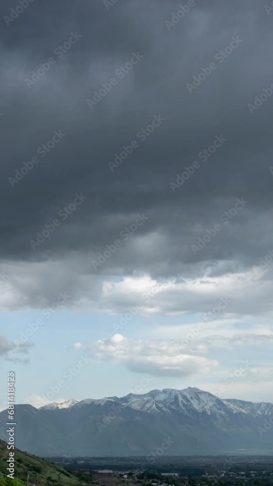 Vertical Timelapse of storm clouds moving over Utah Valley viewing Loafer Mountain and Mt. Nebo in the background.