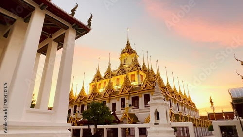 4K Twilight Light  and sunset Pink yellow orange sky changing over Wat Ratchanadda Bangkok Thailand photo