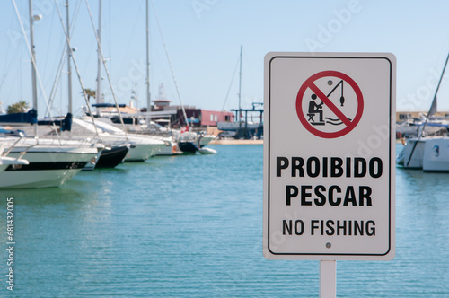 Sign saying "Proibido pescar" (No fishing) at the marina in Vilamoura, Algarve, Portugal
