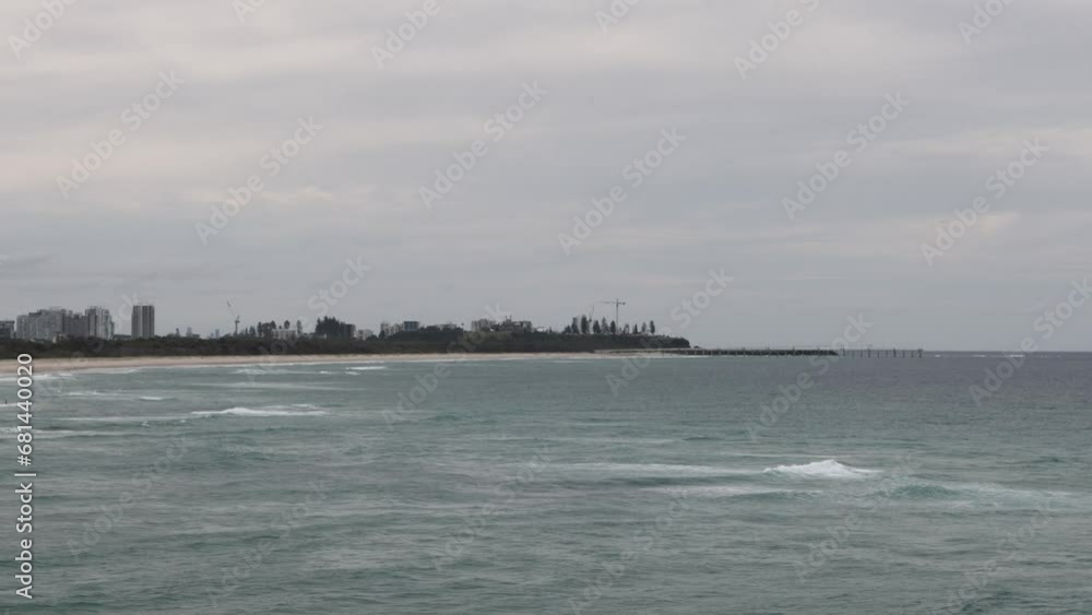 Seascape in Gold Coast, QLD, Australia with a tall building skyscraper in the background Seascape in Gold Coast, QLD, Australia with a tall building skyscraper in the background