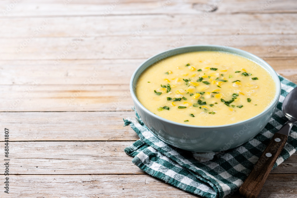 Corn soup in green bowl on wooden table. Copy space Corn soup in green bowl on wooden table. Copy space