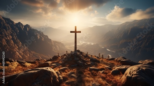 A Christian cross on top of a mountain with a shinin photo