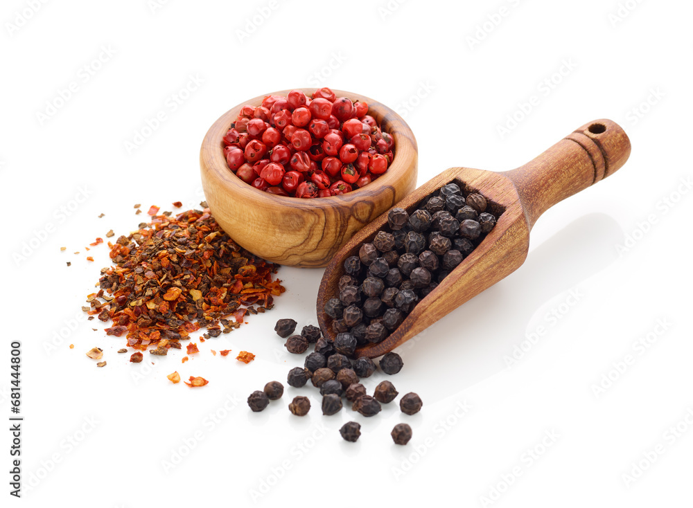 Black pepper in wooden spoon and peppercorn in wooden bowl isolated on white background Black pepper in wooden spoon and peppercorn in wooden bowl isolated on white background