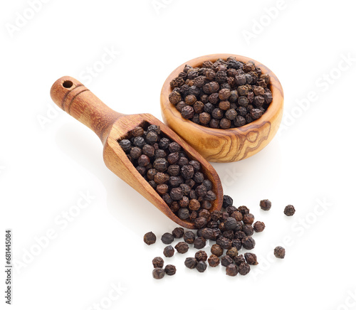 Black pepper in wooden spoon and bowl isolated on white background