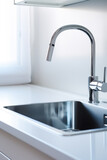Stainless steel kitchen sink with modern faucet